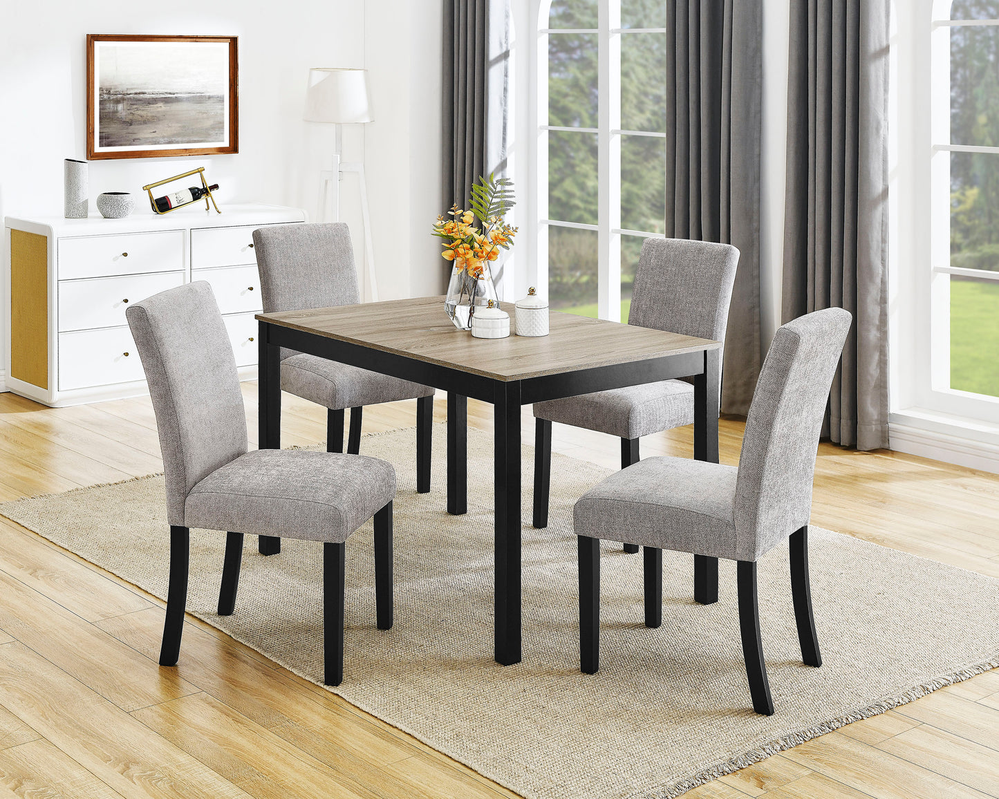 Modern dining table with four grey upholstered chairs and black legs
