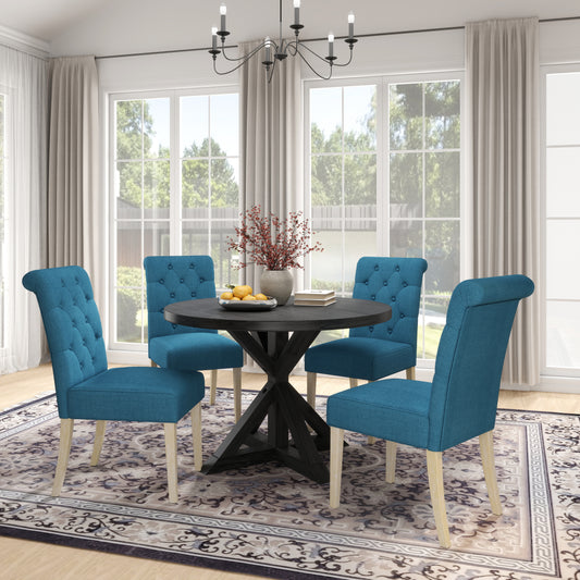 Teal upholstered dining chairs with tufted backs around a dark wood pedestal table