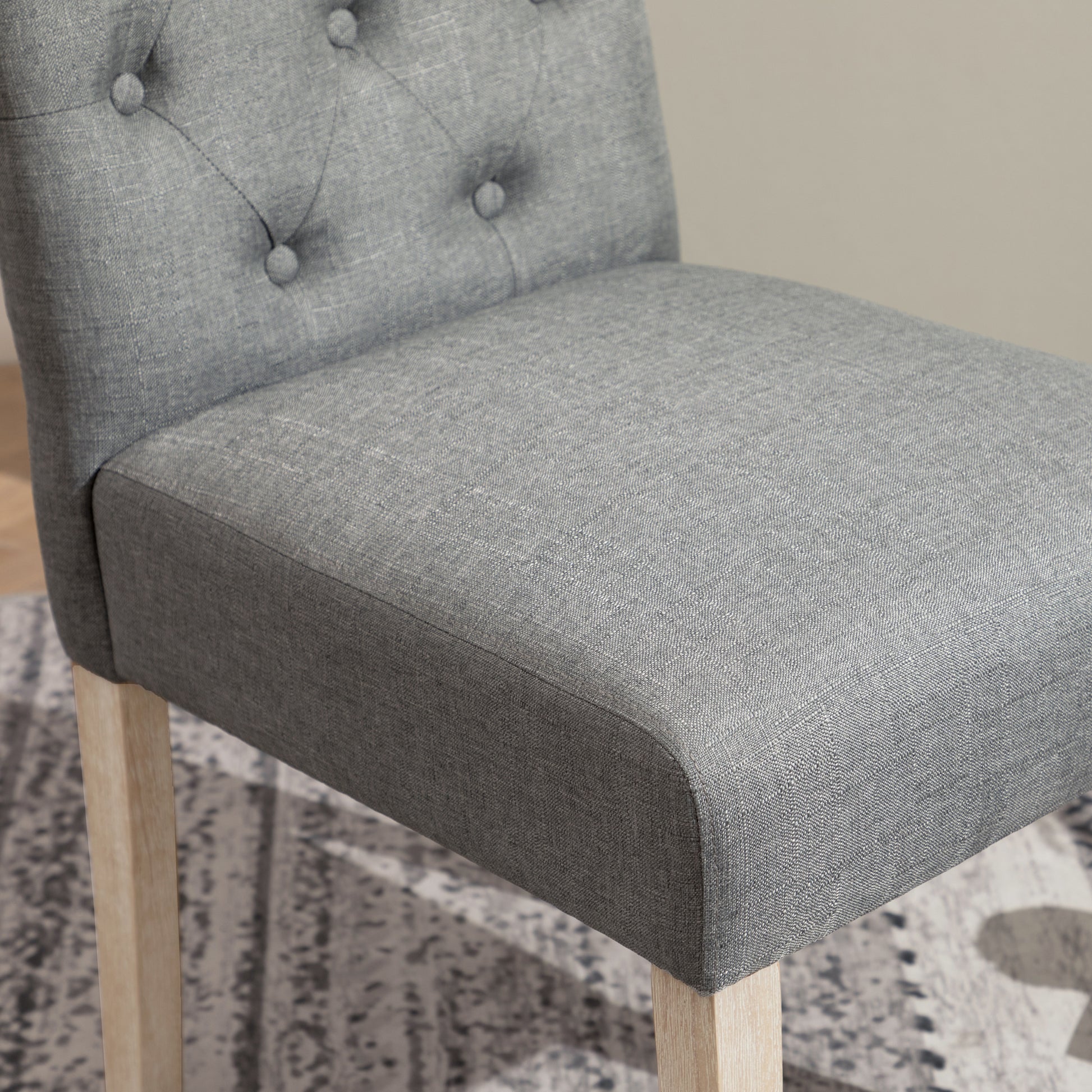 Tufted grey fabric armchair seat and backrest