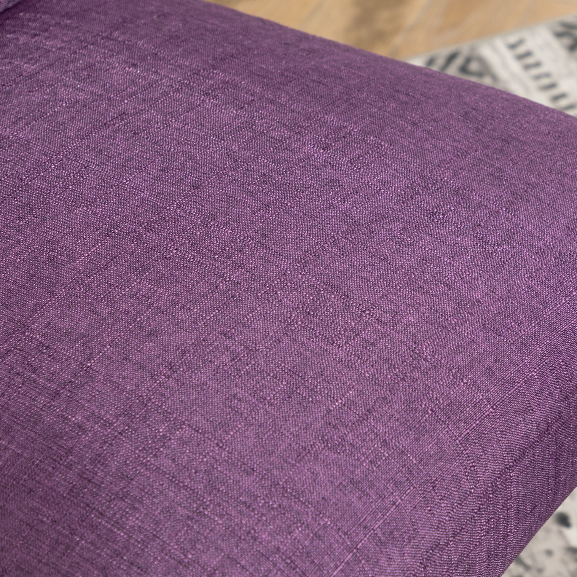 Closeup of textured purple linen fabric