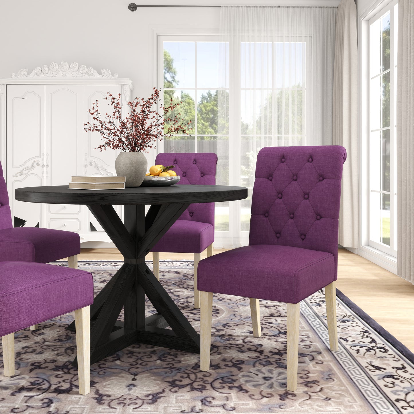 Deep purple tufted dining chairs around a dark wood round table