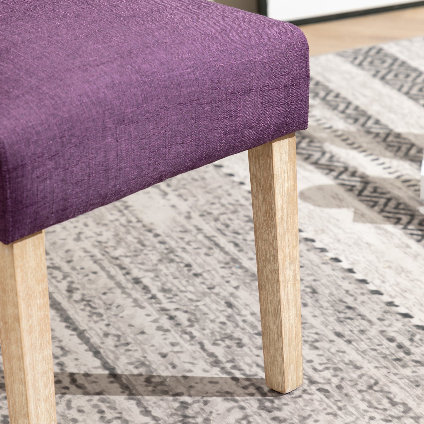 Deep purple linen upholstered dining chair with natural wood legs