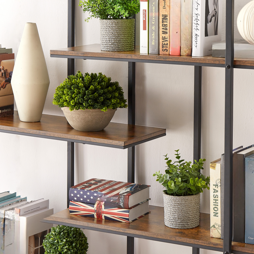 Tall ribbed cream ceramic vase on a wooden shelf