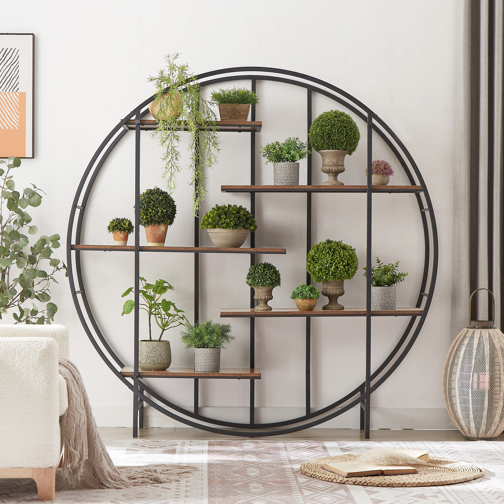 Round metal bookshelf filled with assorted artificial plants
