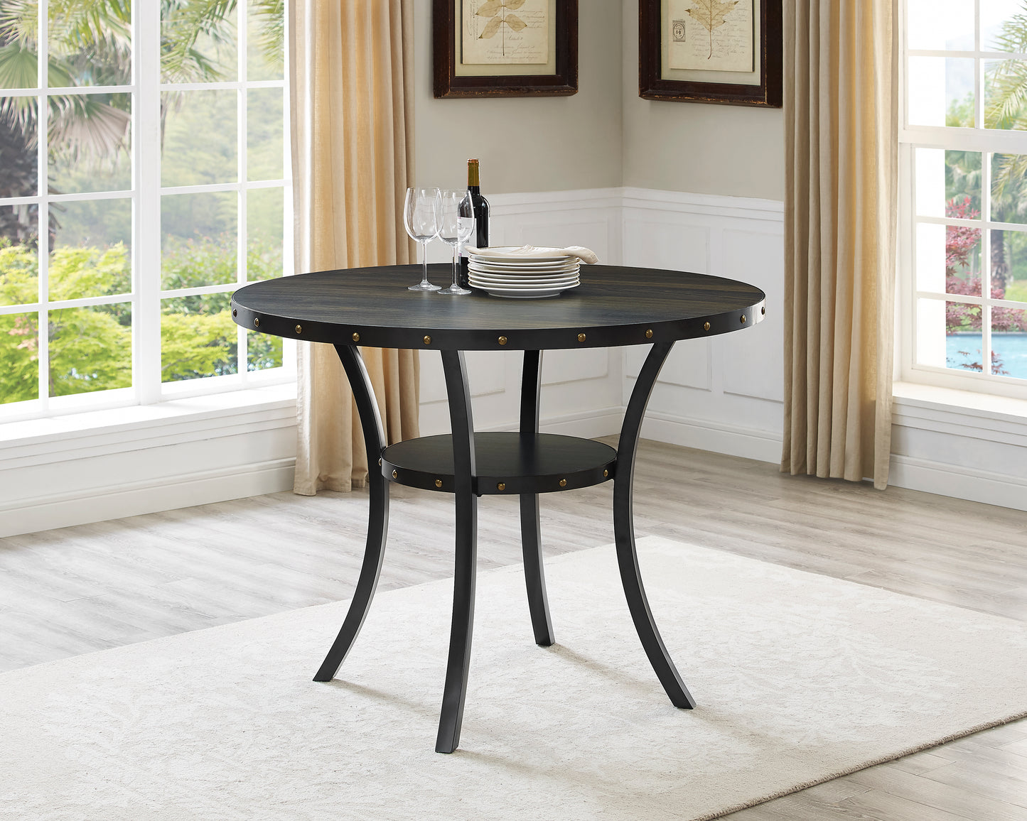 Dark wood round dining table with metal legs and studded detail