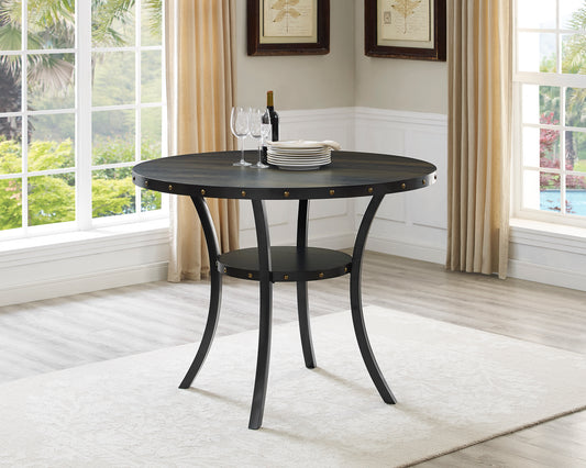 Dark wood round dining table with metal legs and studded detail