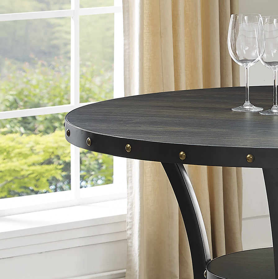 Dark wood round dining table with riveted metal edge detail