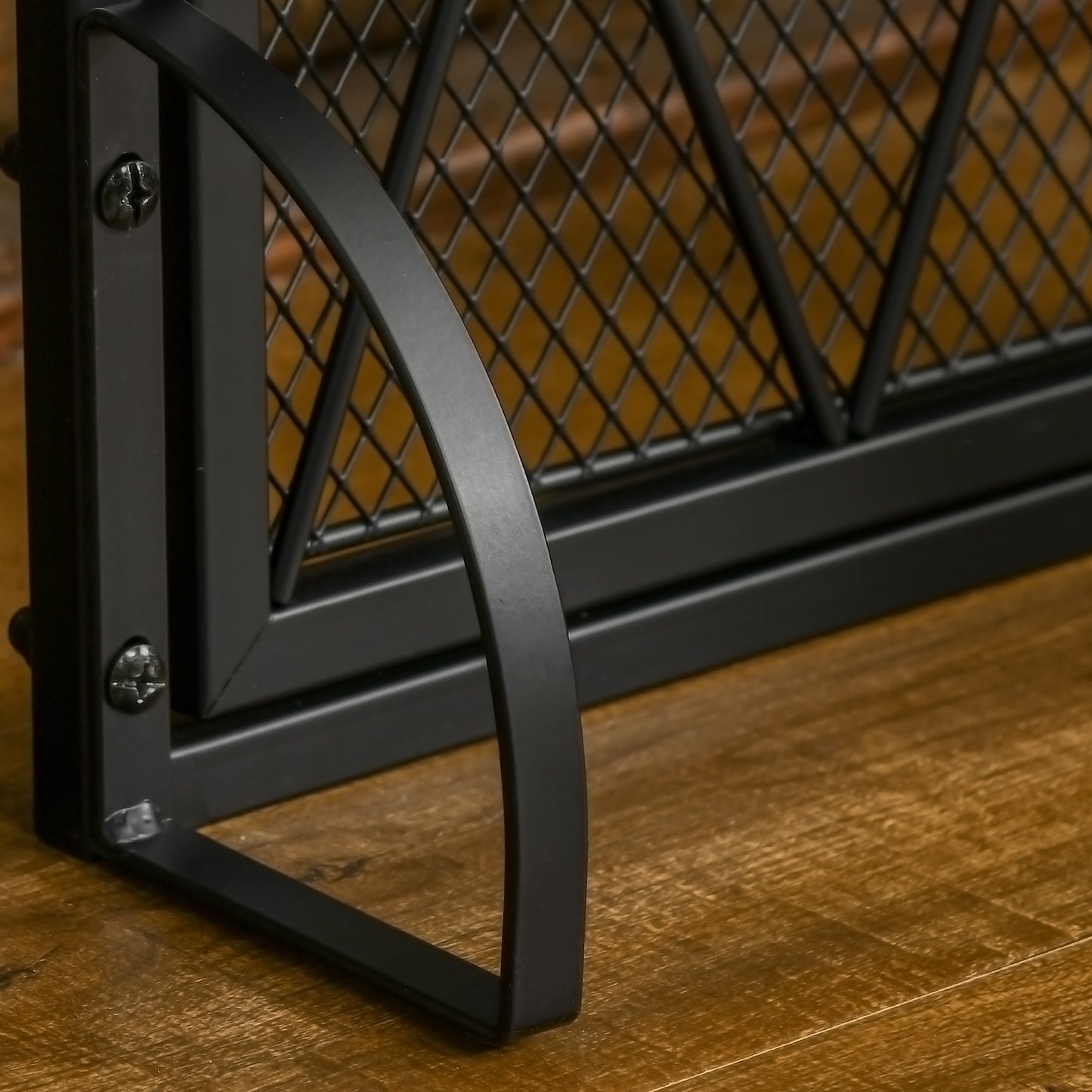 Closeup of black metal industrial bookshelf corner with diamond mesh backing