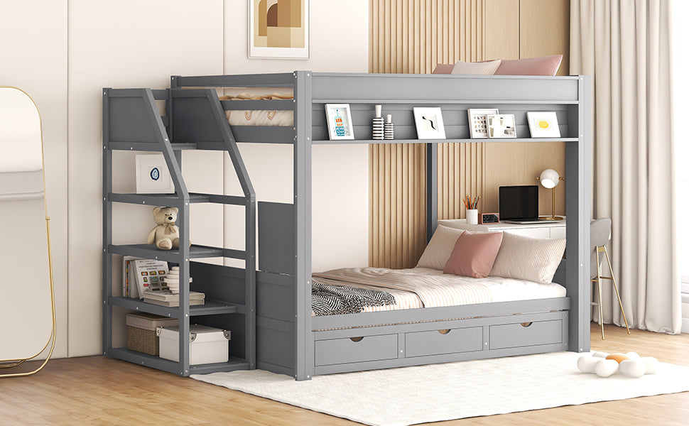 Gray wooden triple bunk bed with storage shelves and drawers