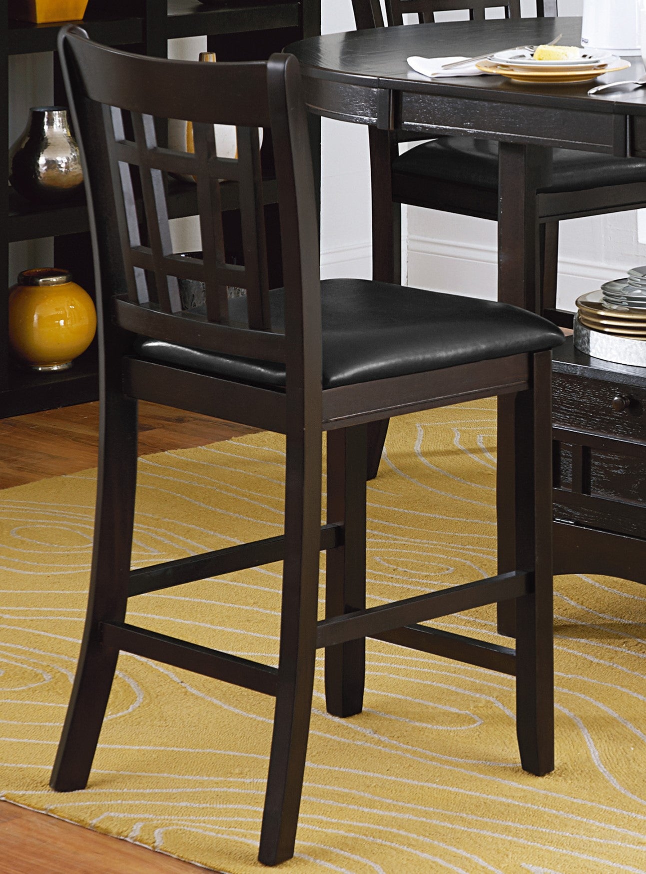 Dark espresso wood bar stool with black upholstered seat and geometric back