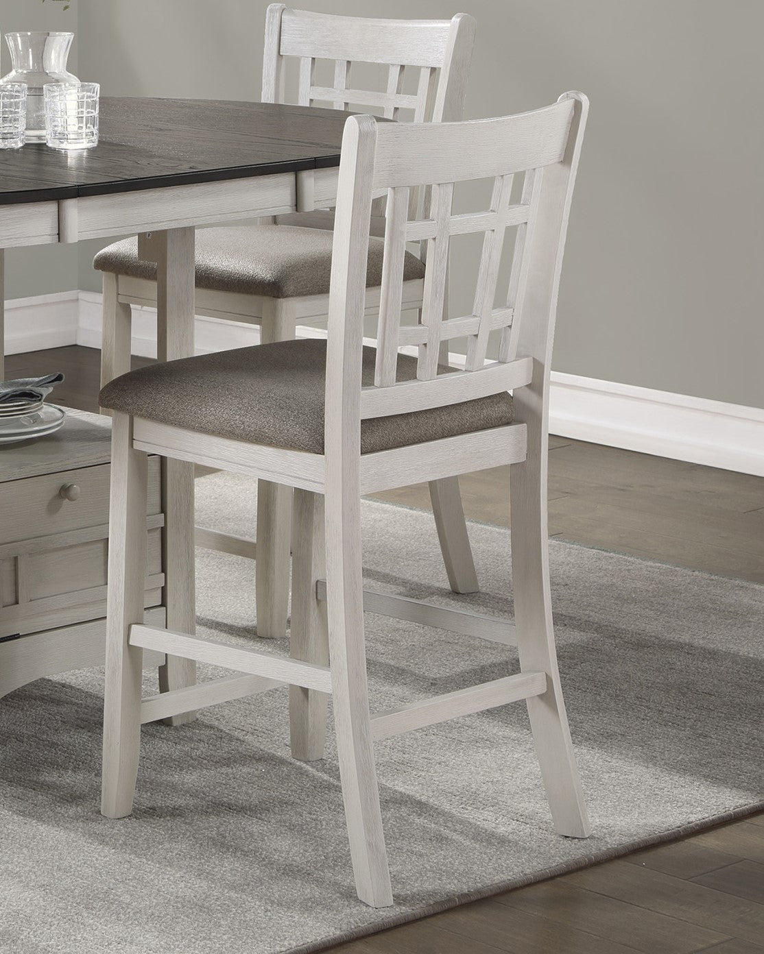 Distressed white wood bar stool with gray upholstered seat and lattice back