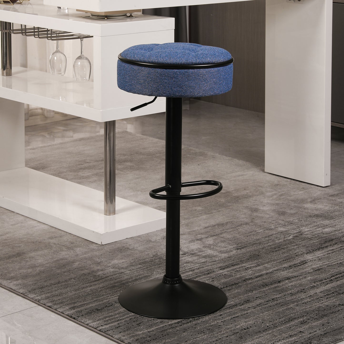 Adjustable blue fabric bar stool with black metal base and footrest