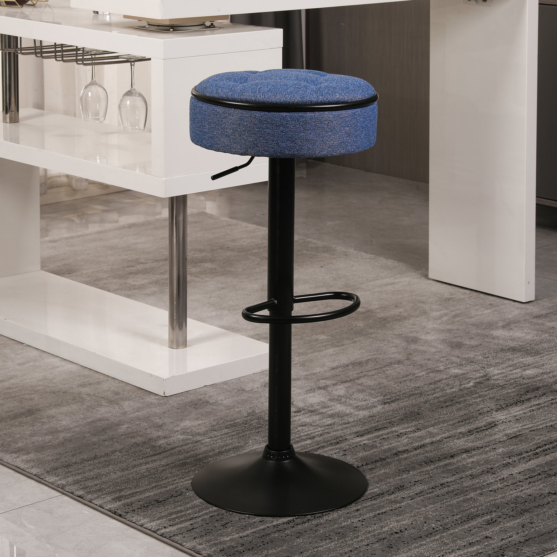Adjustable blue fabric bar stool with black metal base and footrest