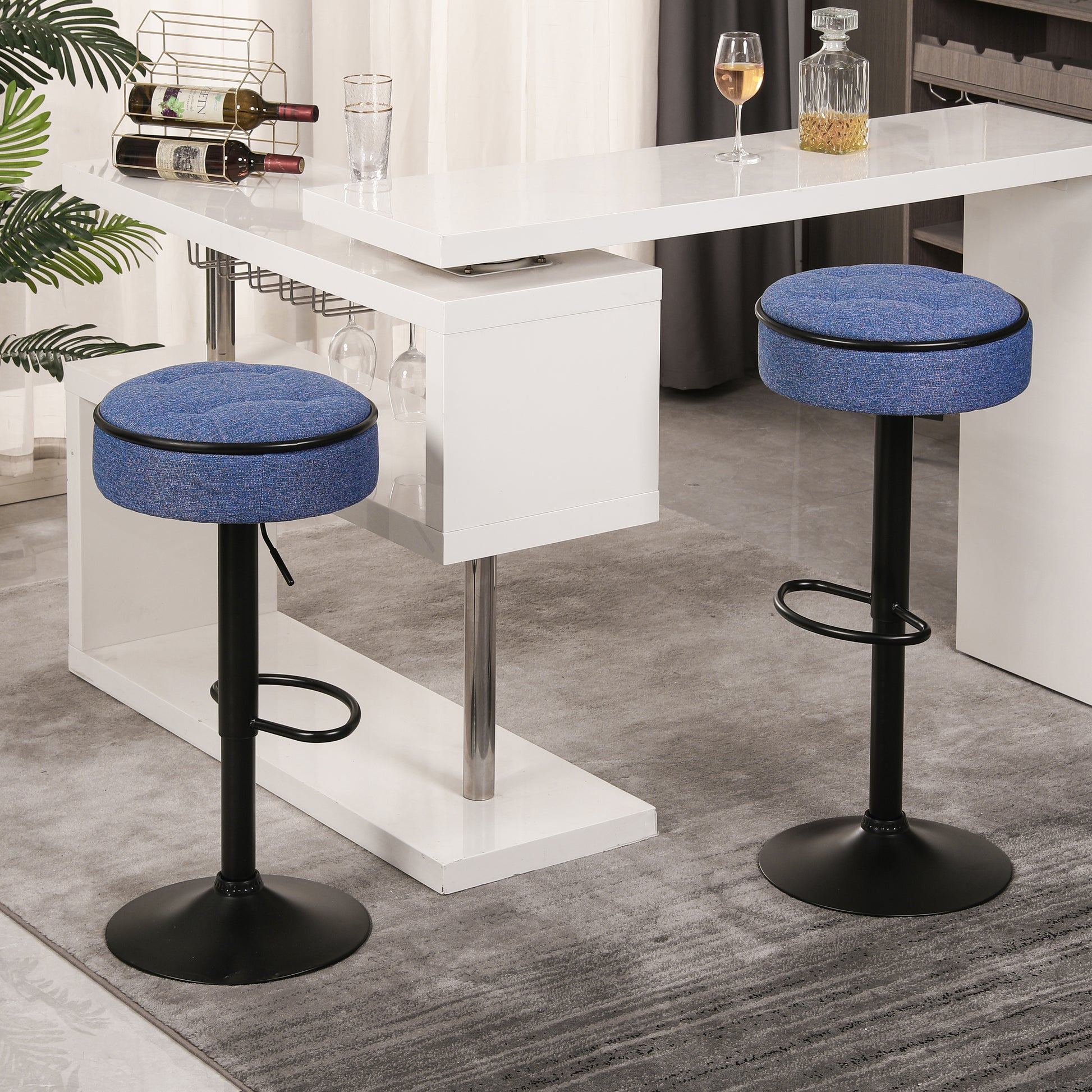 Blue upholstered bar stool with black metal base and footrest