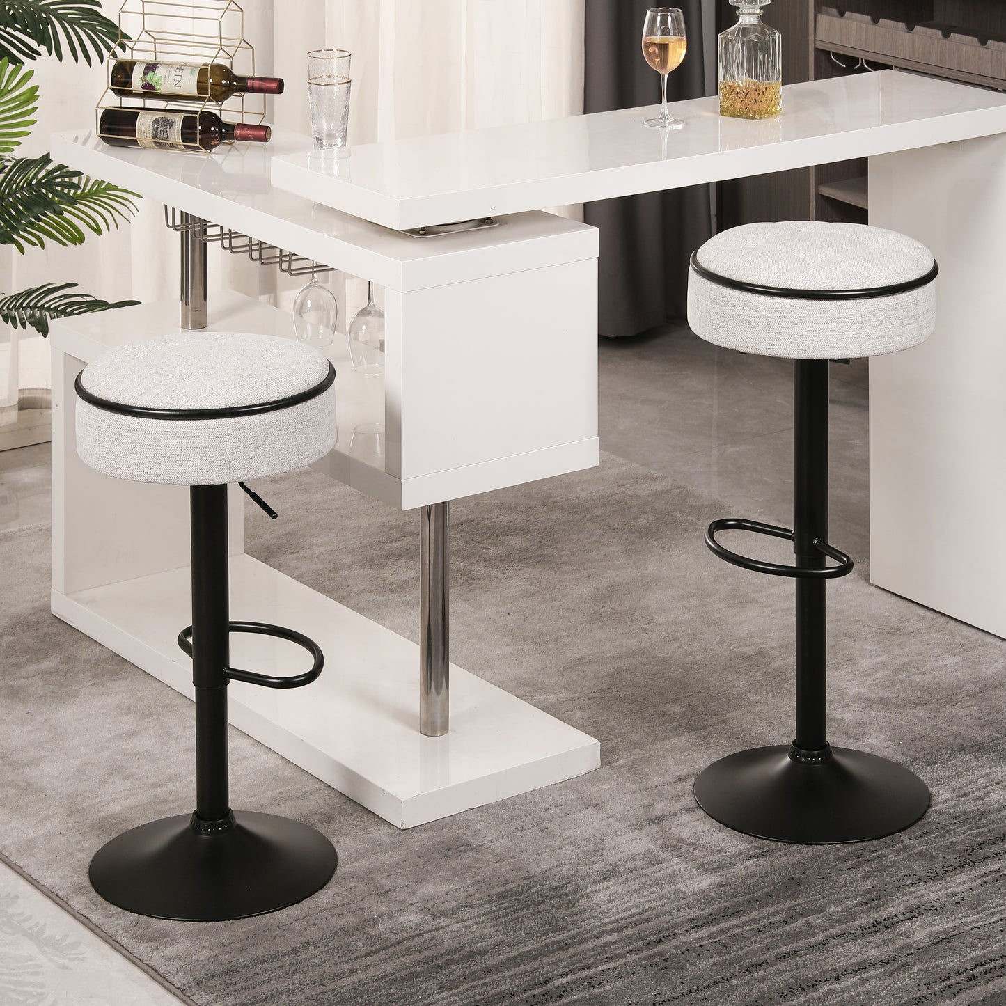 Adjustable height bar stool with light gray fabric seat and black metal base