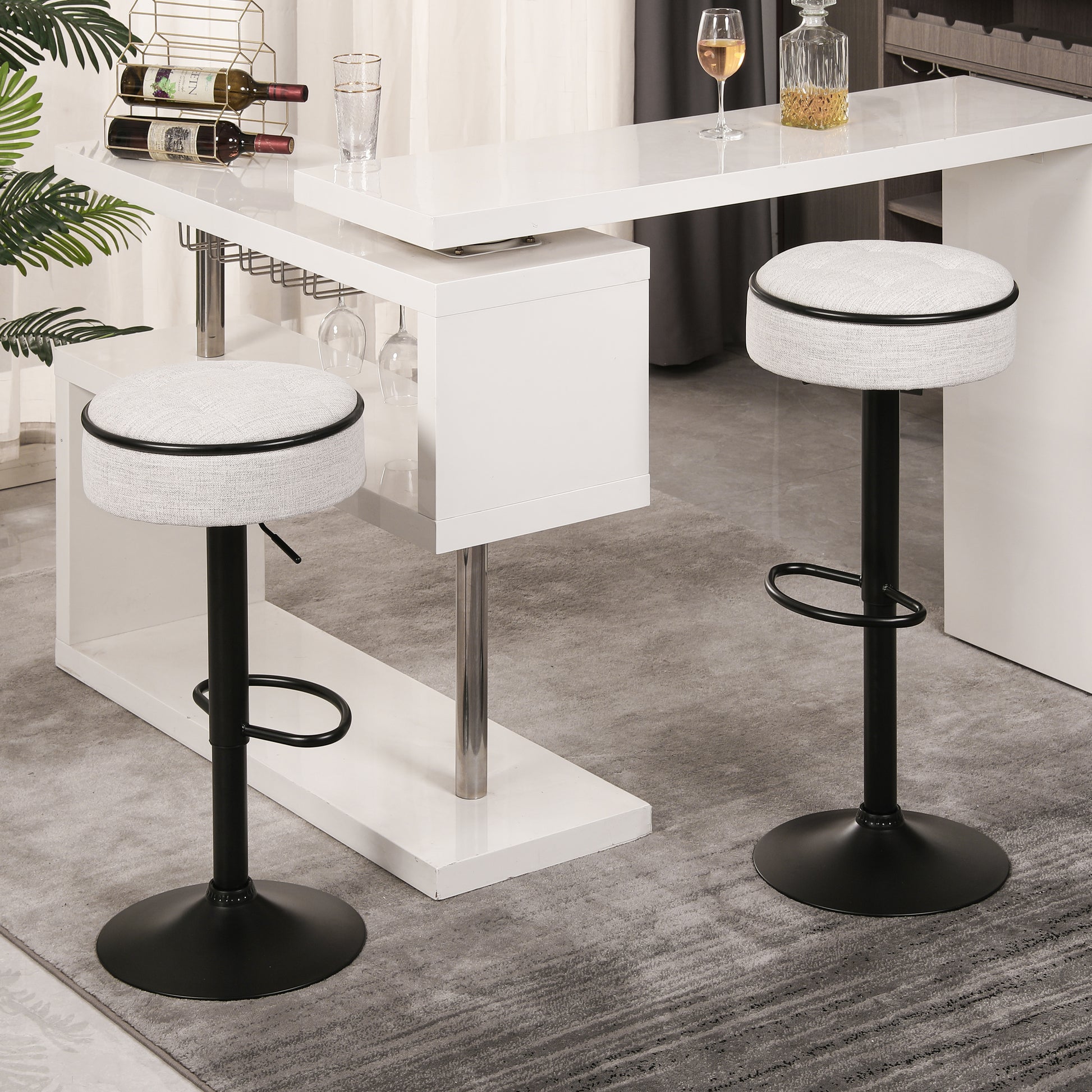 Adjustable height bar stool with light gray fabric seat and black metal base