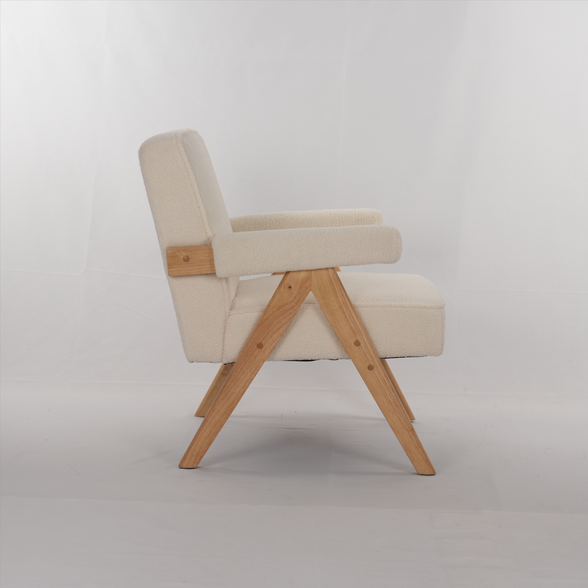Cream boucle armchair with natural wood frame and angled legs