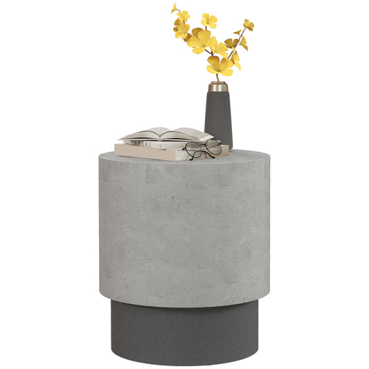 Gray concrete cylindrical end table with a book glasses and yellow floral decor