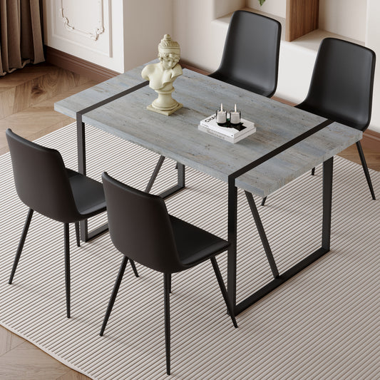 Gray wood dining table with black metal legs and chairs