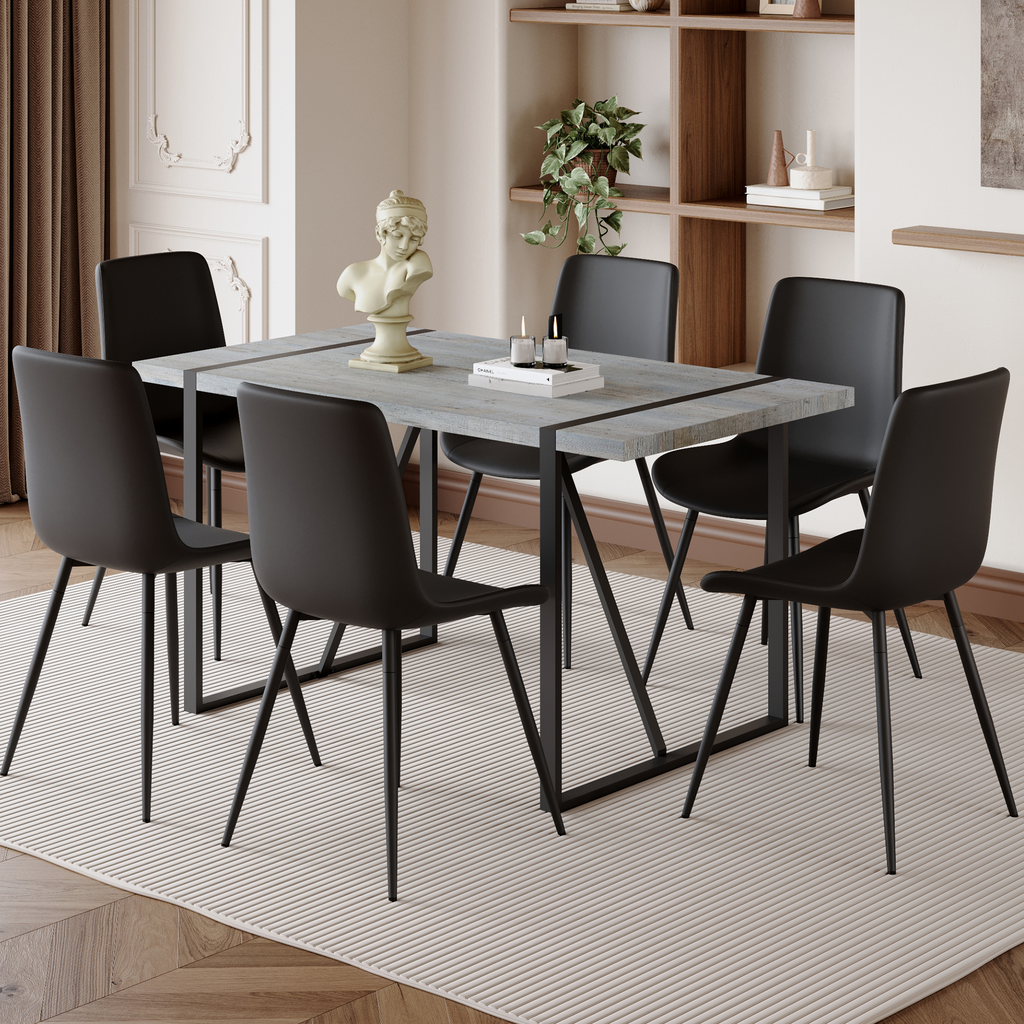 Modern dining set with six black upholstered chairs around a distressed gray wood table
