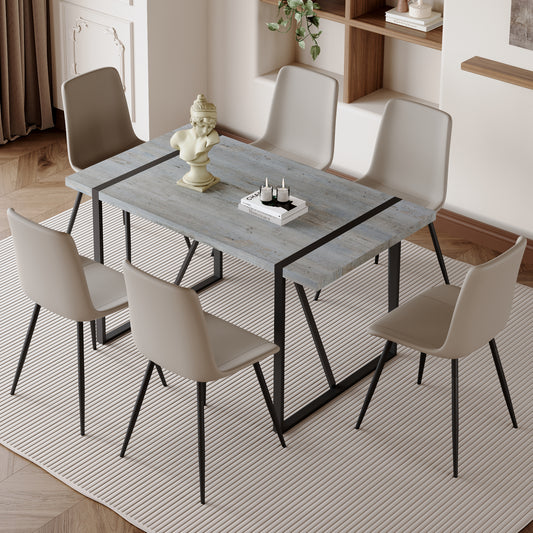 Rustic grey wood dining table with black metal legs and six beige chairs