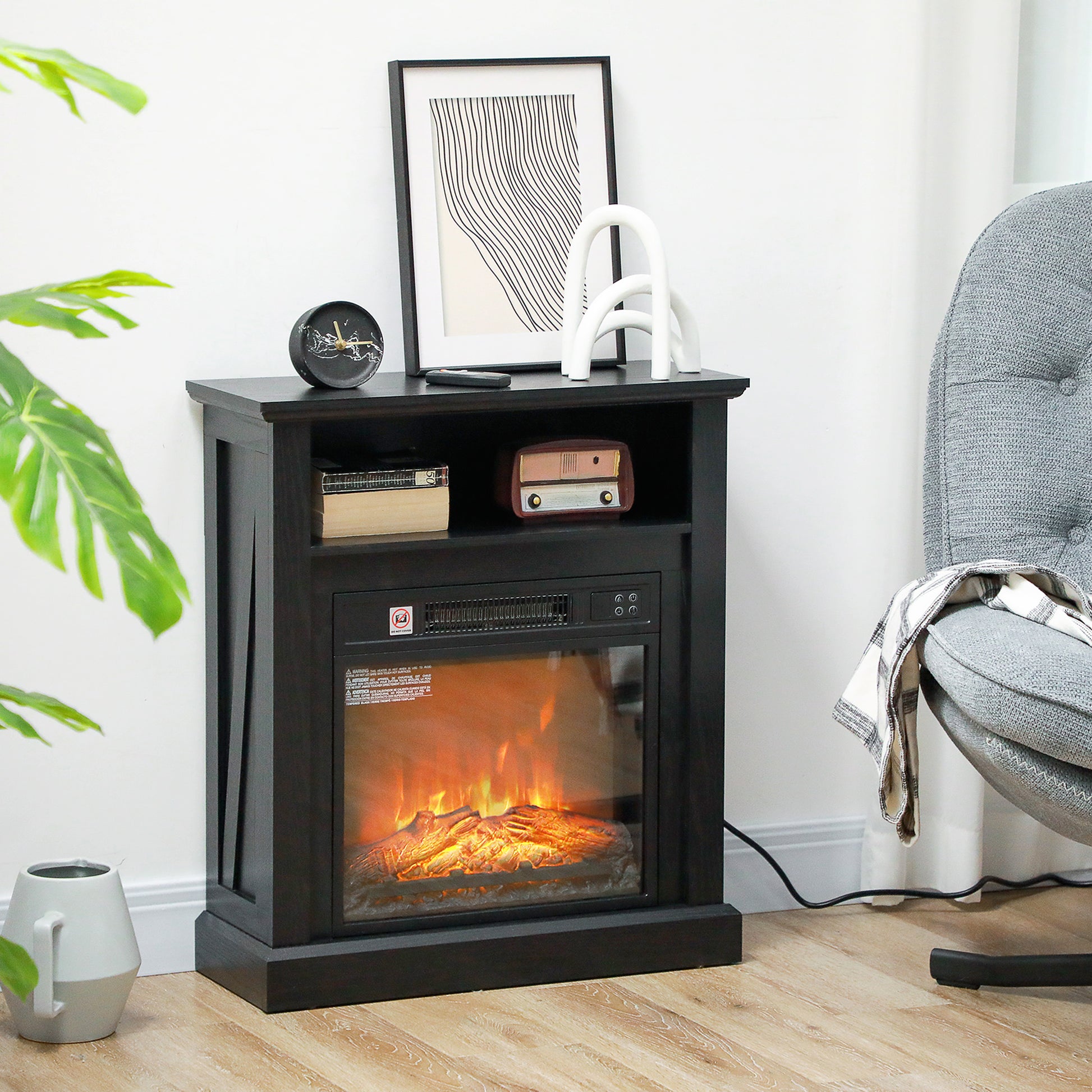 Black electric fireplace with realistic flame effect and wood log details