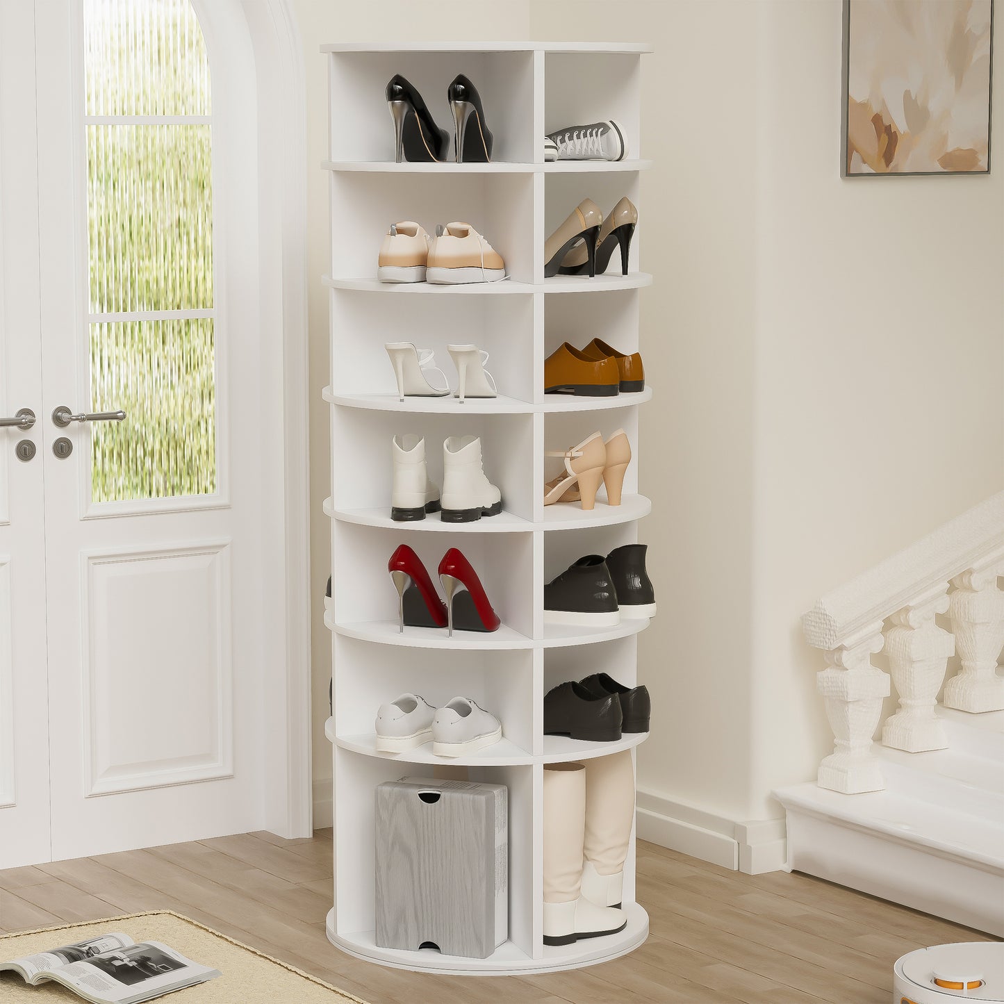 White rotating shoe rack with heels and sneakers displayed on shelves