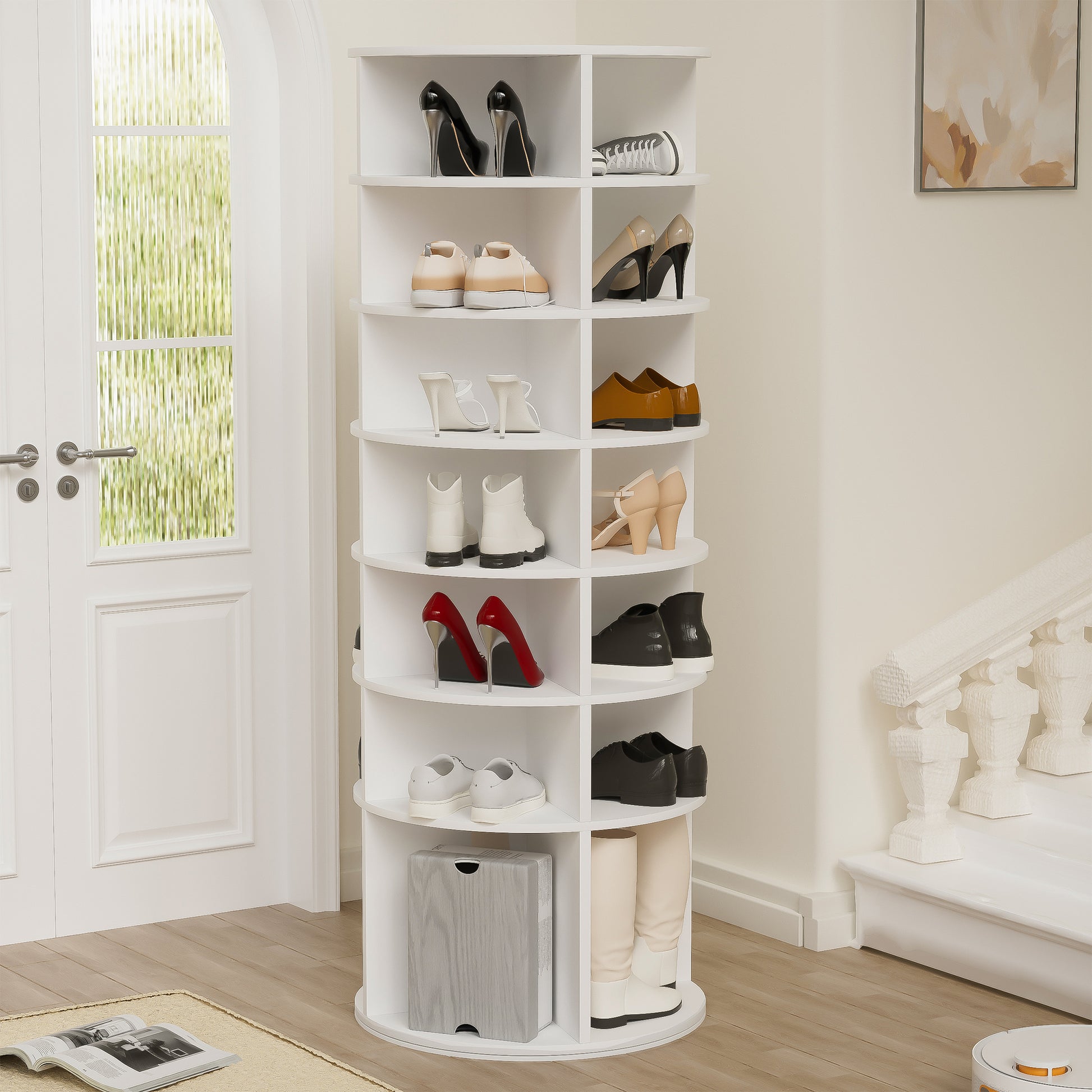 White rotating shoe rack with heels and sneakers displayed on shelves