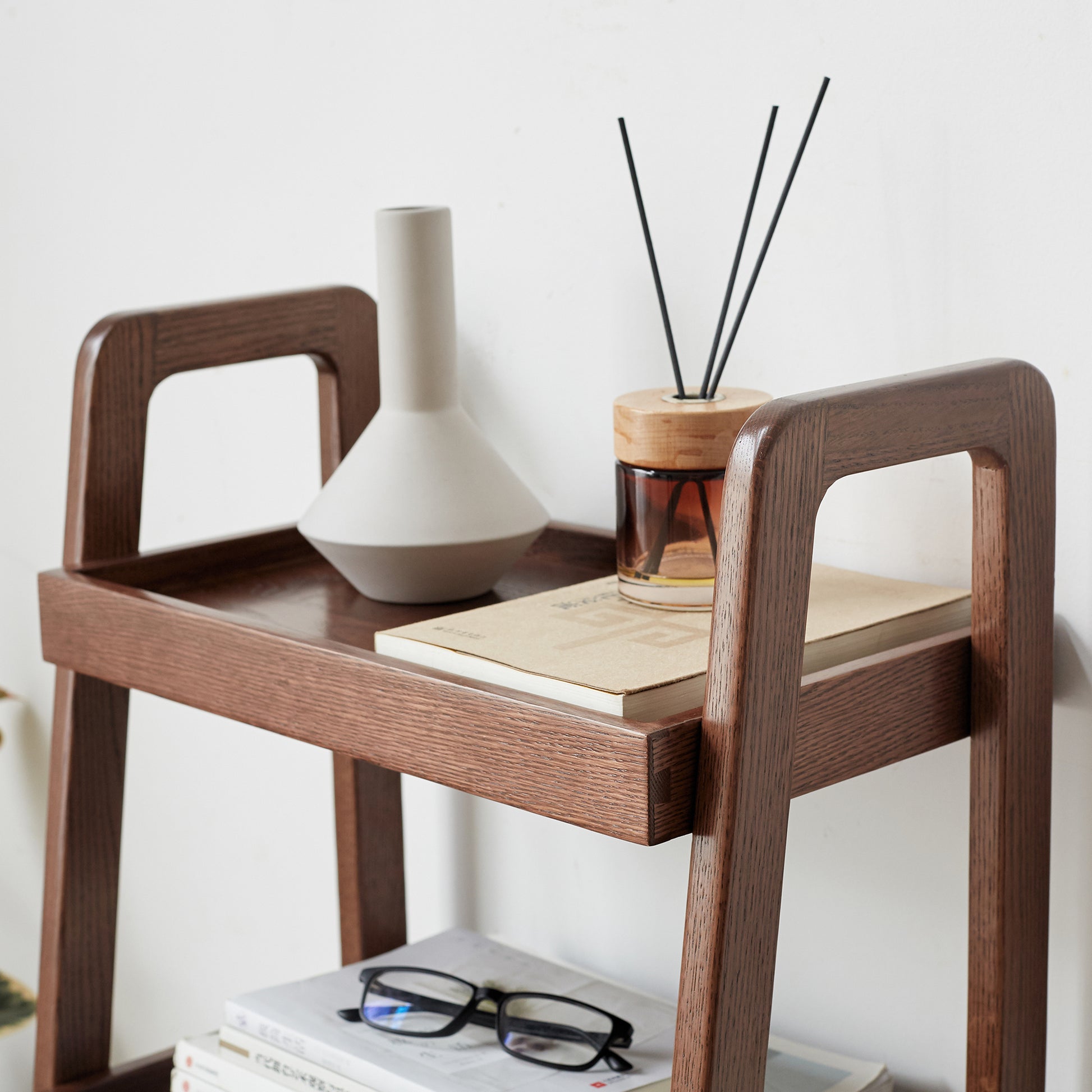 Modern minimalist wood shelf with ceramic vase and diffuser