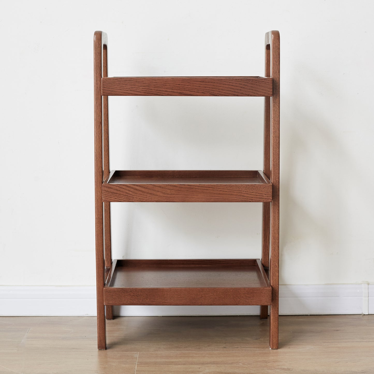 Dark brown wooden tiered shelf with a modern ladder design