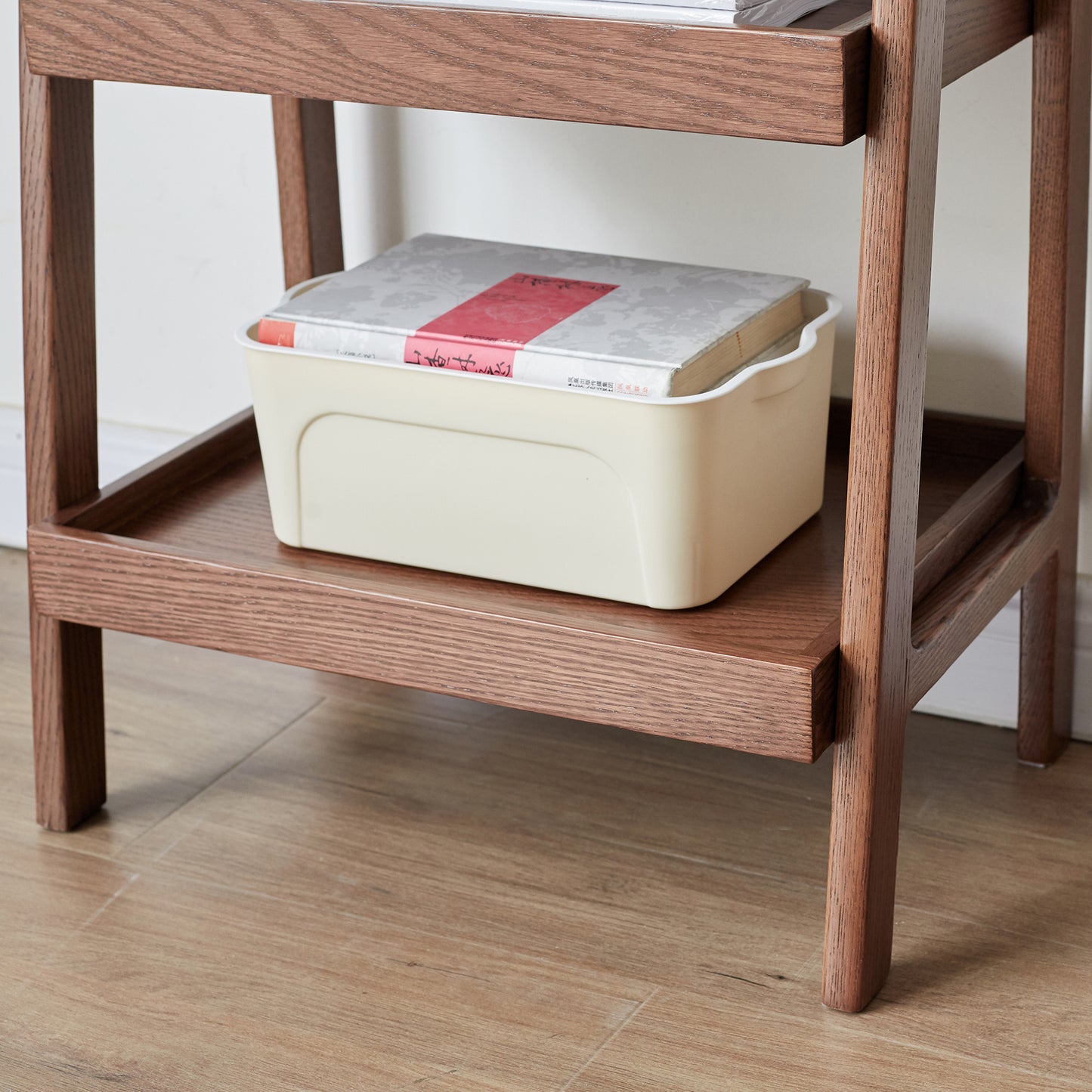 Cream plastic storage bin with books