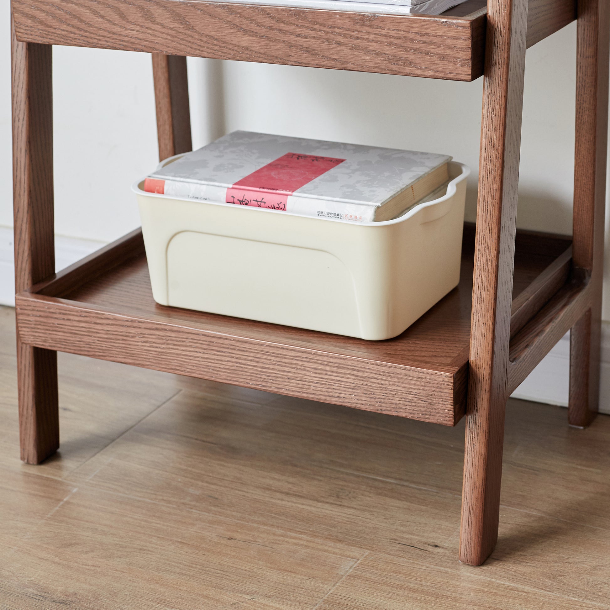 Cream plastic storage bin with books