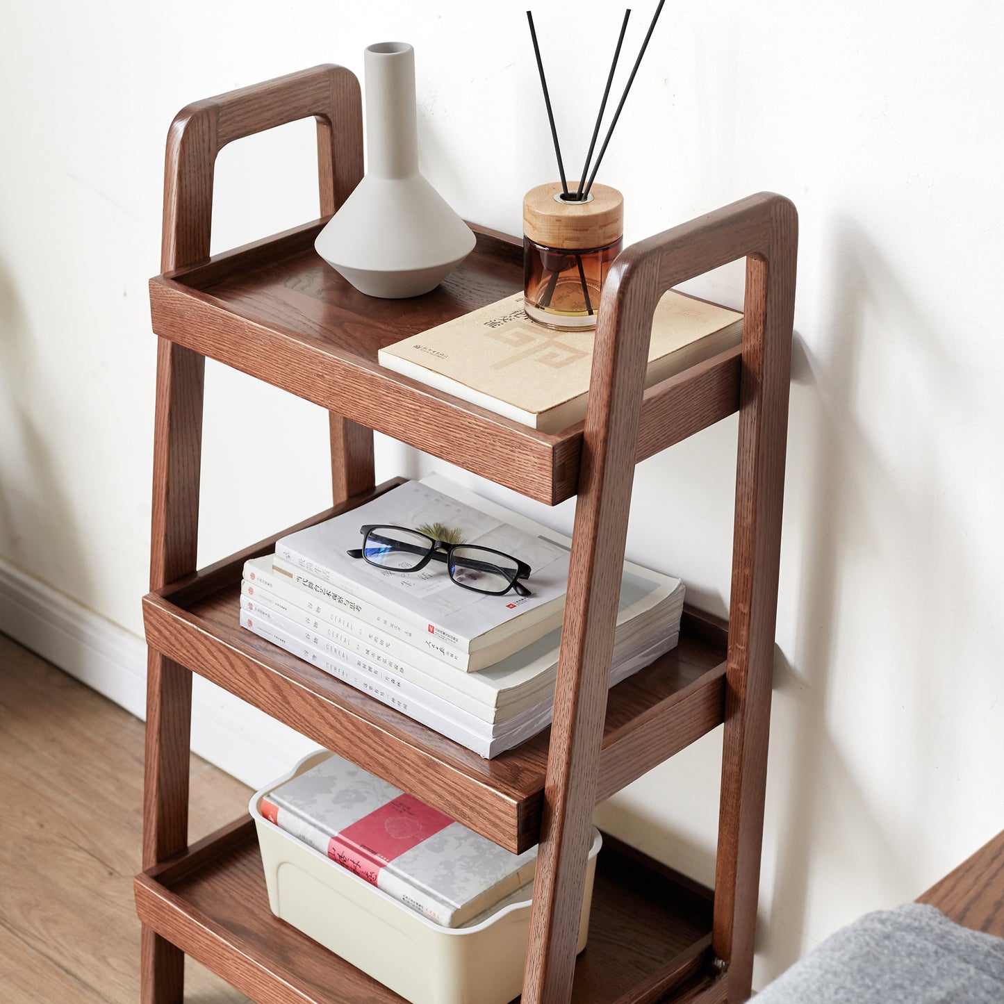 Threetier oak wood side table with decorative items