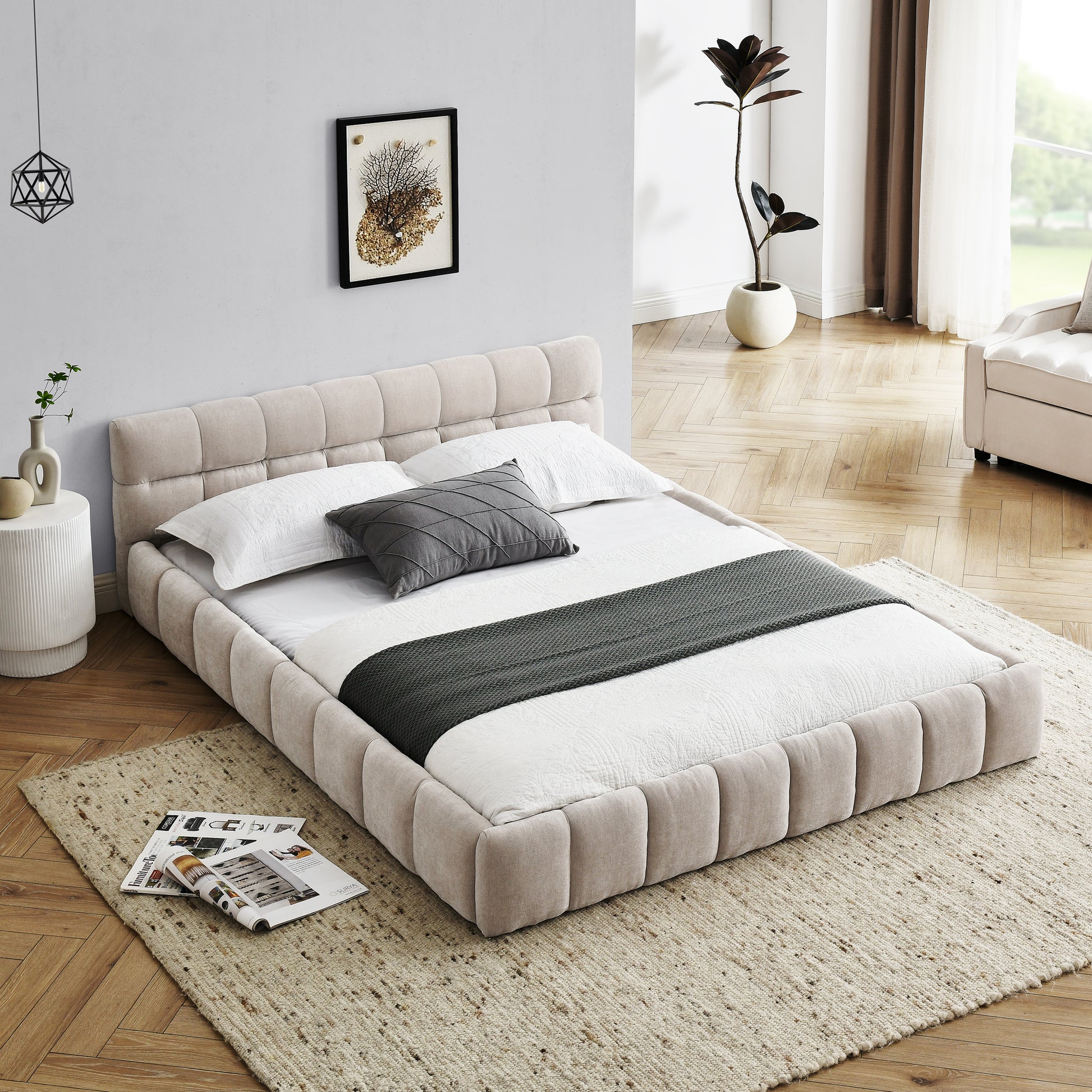 Beige upholstered platform bed with tufted headboard and white linens