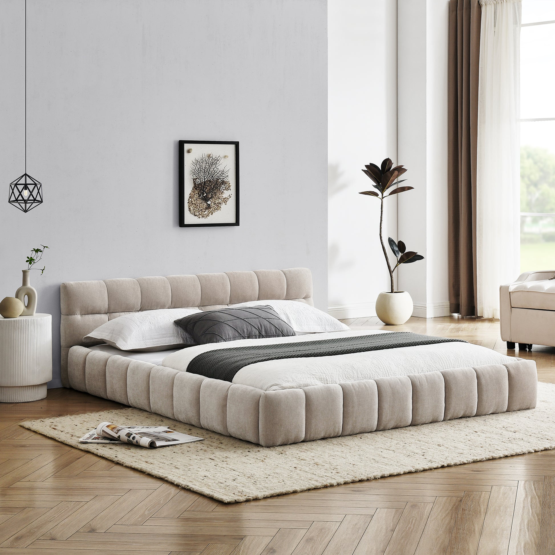 Upholstered beige platform bed with padded headboard and bedding