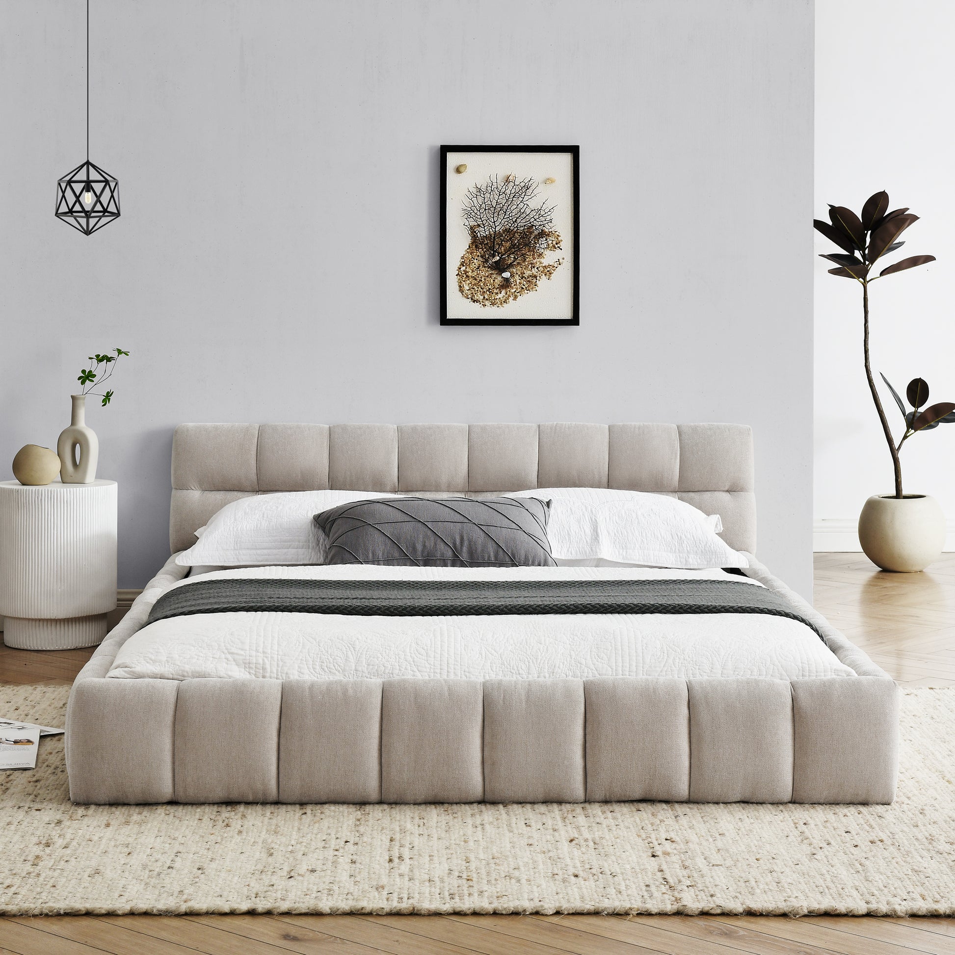 Upholstered platform bed in beige fabric with quilted detailing and padded headboard
