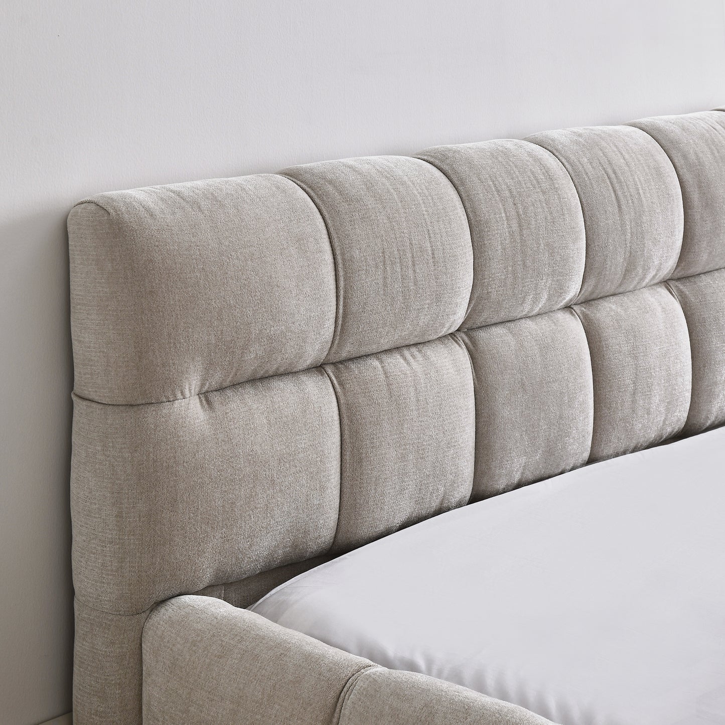 Tufted beige upholstered headboard with clean lines for a modern bedroom