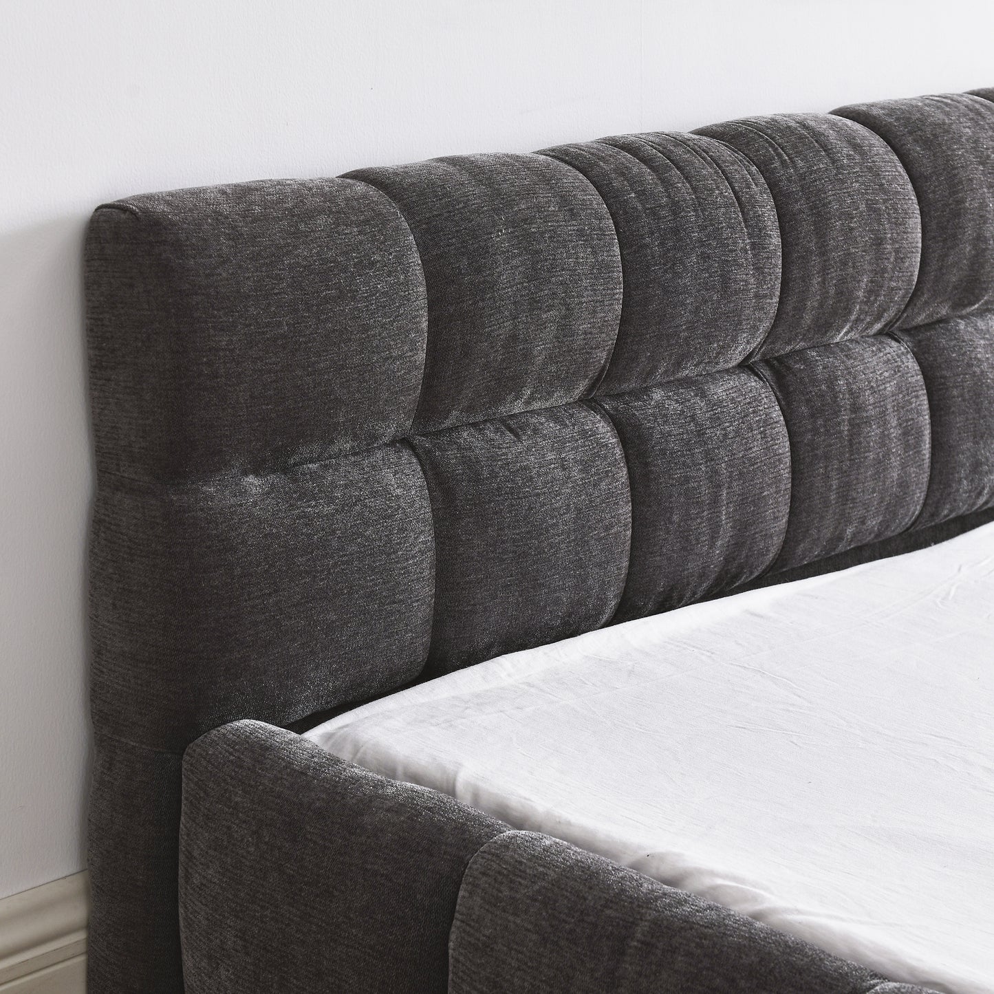 Dark gray tufted fabric headboard