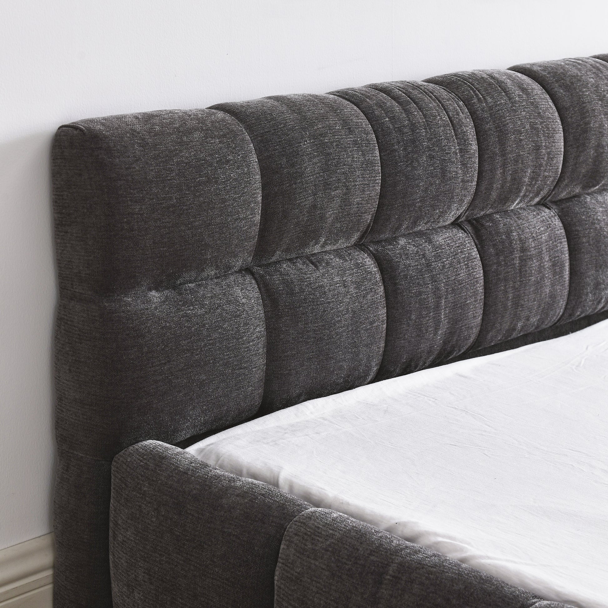 Dark gray tufted fabric headboard