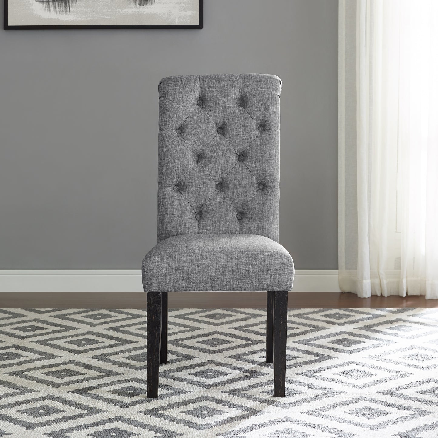 Tufted grey fabric dining chair with dark wood legs