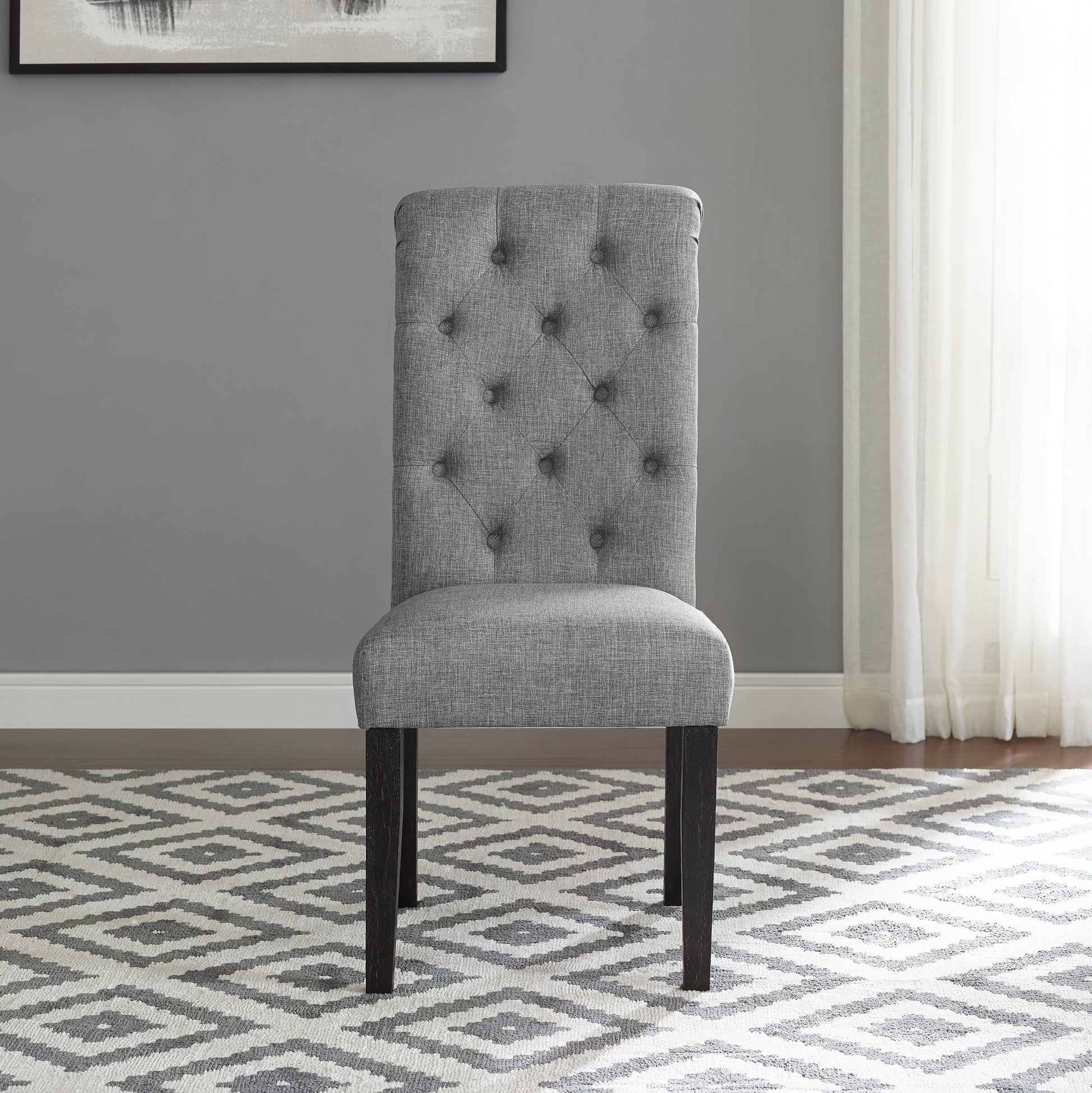 Tufted grey fabric dining chair with dark wood legs