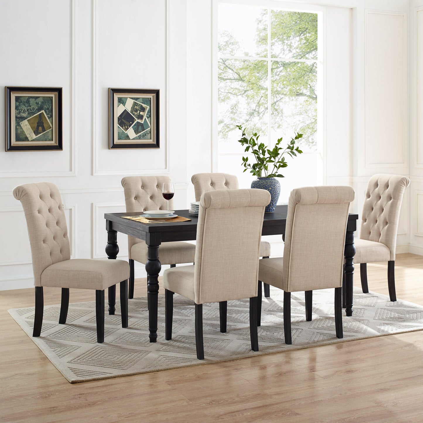 Tufted beige dining chairs surrounding a dark wood table