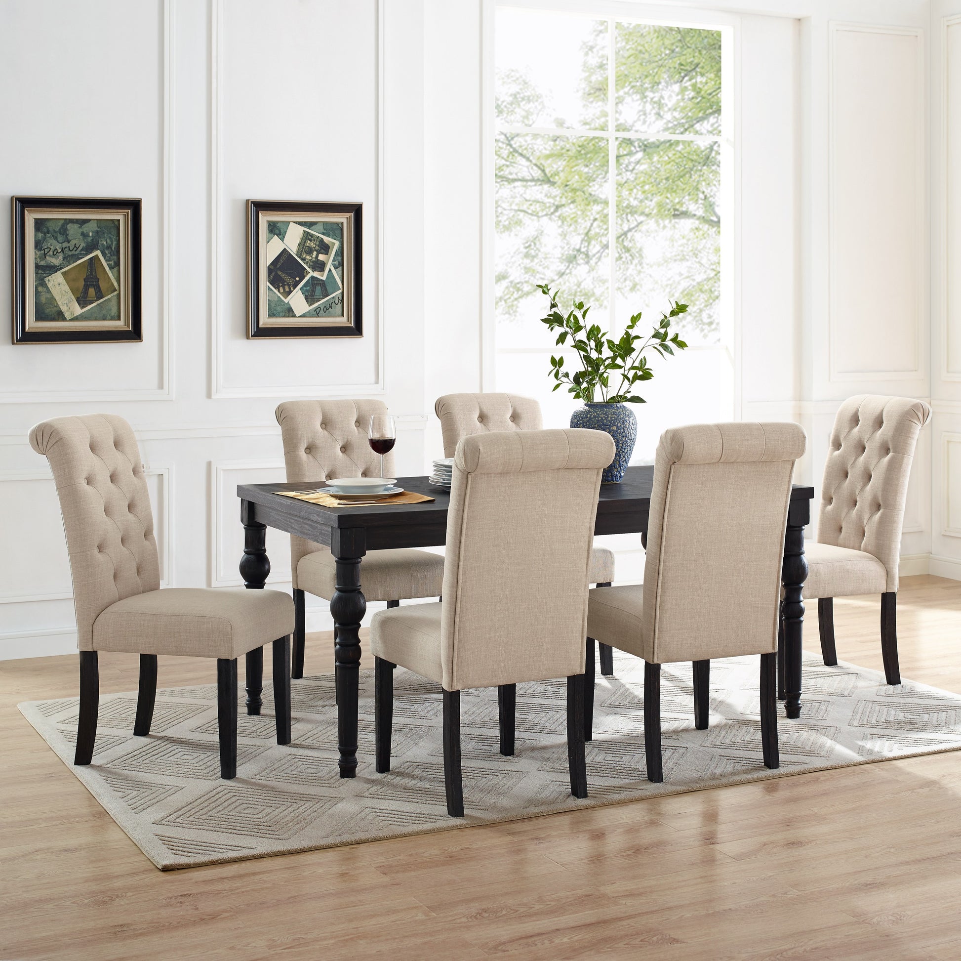 Tufted beige dining chairs surrounding a dark wood table