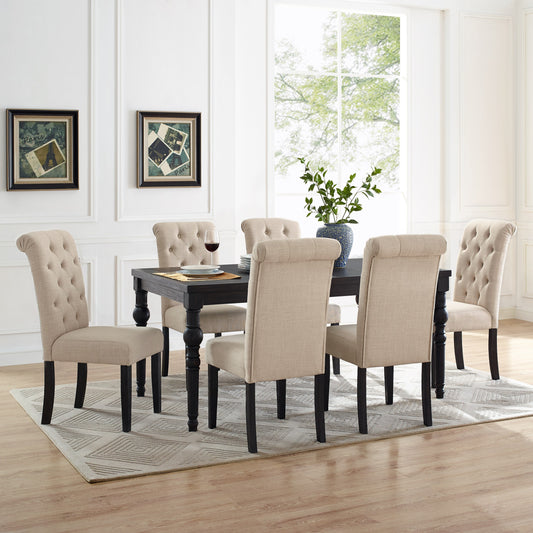 Tufted beige dining chairs surrounding a dark wood table