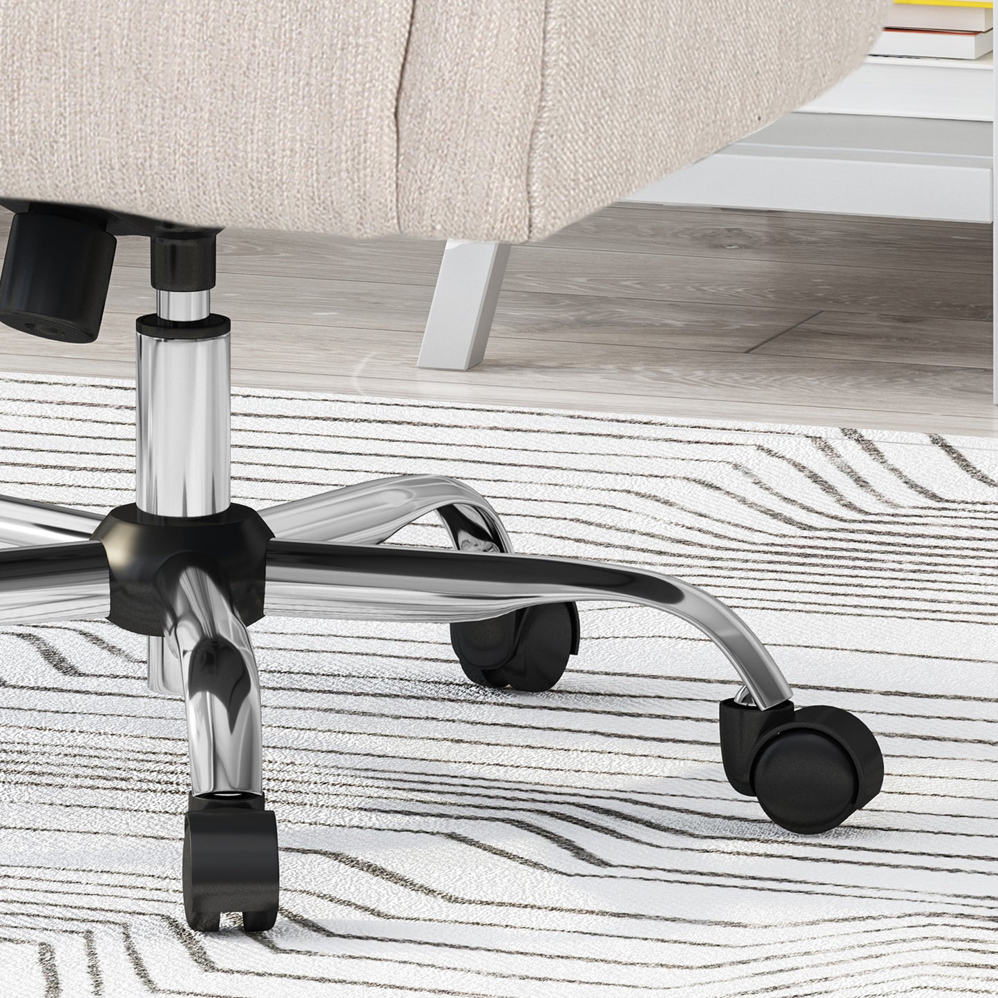 Cream fabric office chair base with chrome and black casters on striped rug