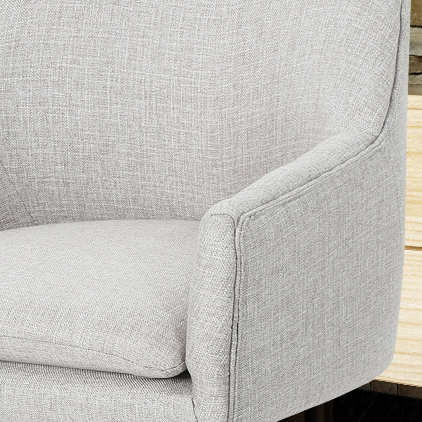 Light gray textured fabric armchair armrest and seat detail