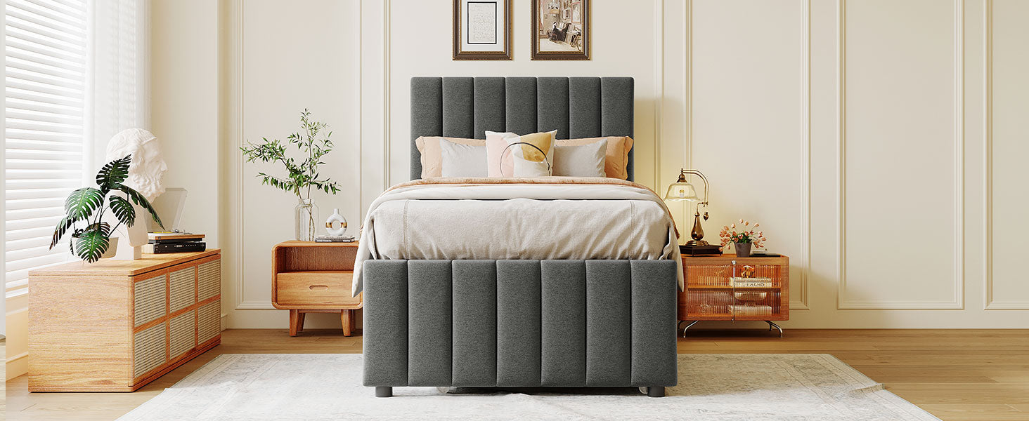 Upholstered grey velvet twin bed frame with vertical channel tufting on headboard and base