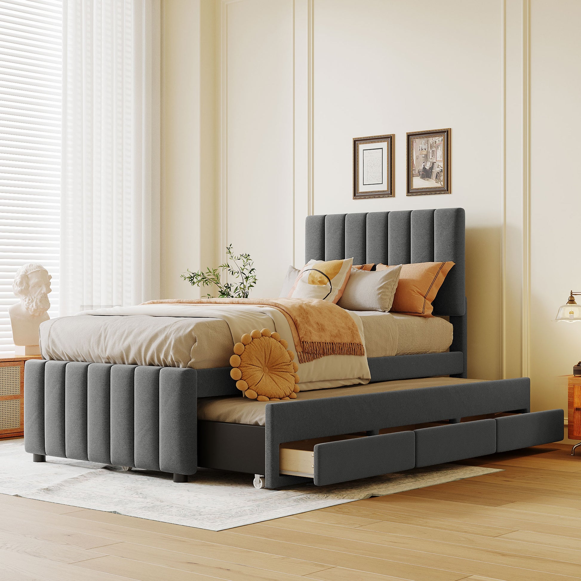 Dark gray upholstered platform bed with tufted headboard and pullout trundle