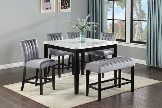 Gray velvet bar stools and bench around a marbletop pub table