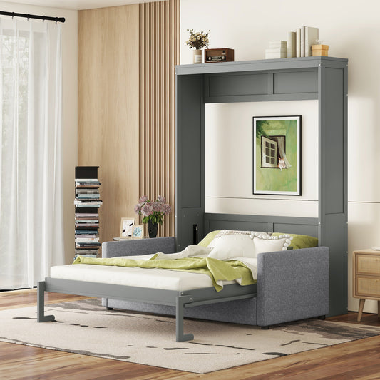 Gray upholstered sofa bed extended with green throw blanket and white pillows